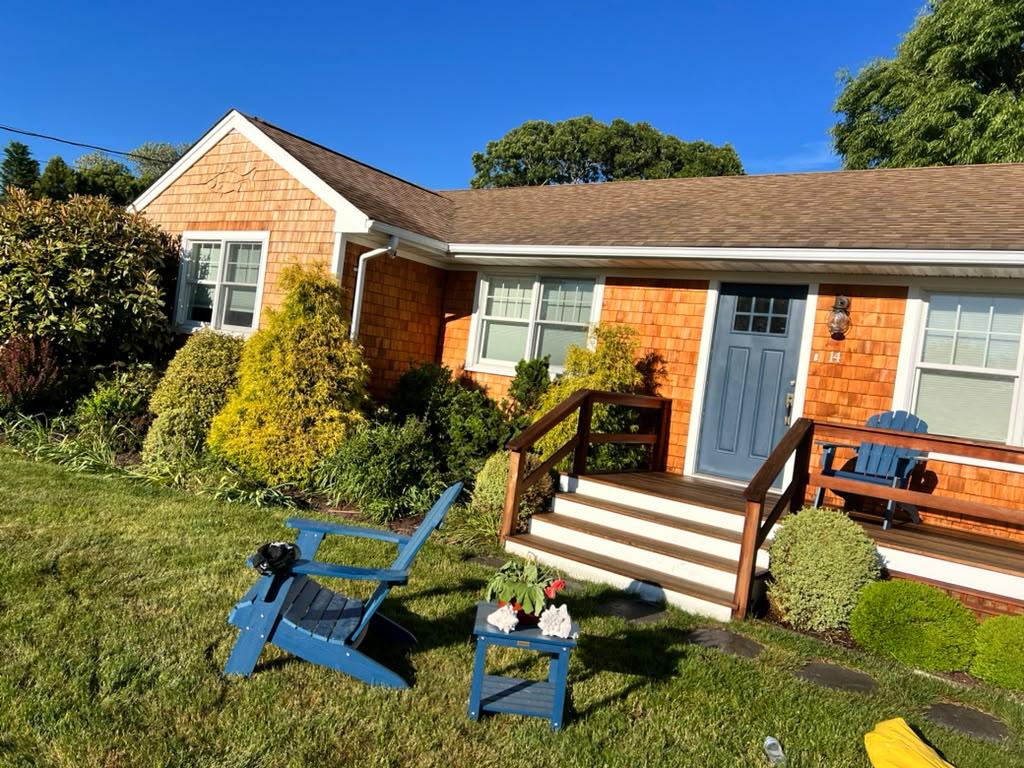 Cedar ranch house with blue door and new railings