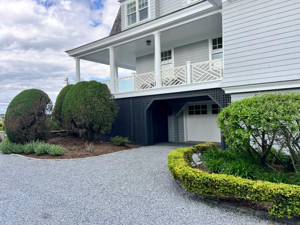 Porch and garage of a gray shingle home