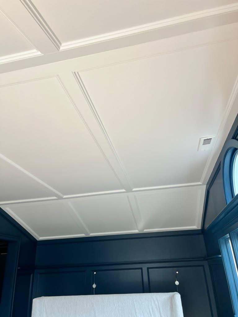 White coffered ceiling with navy built-ins
