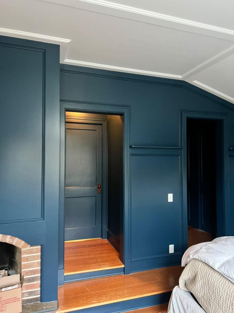 Blue painted bedroom wall panels and door