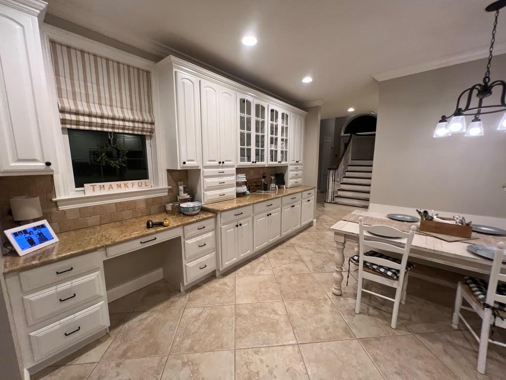 White kitchen cabinets and built-in desk